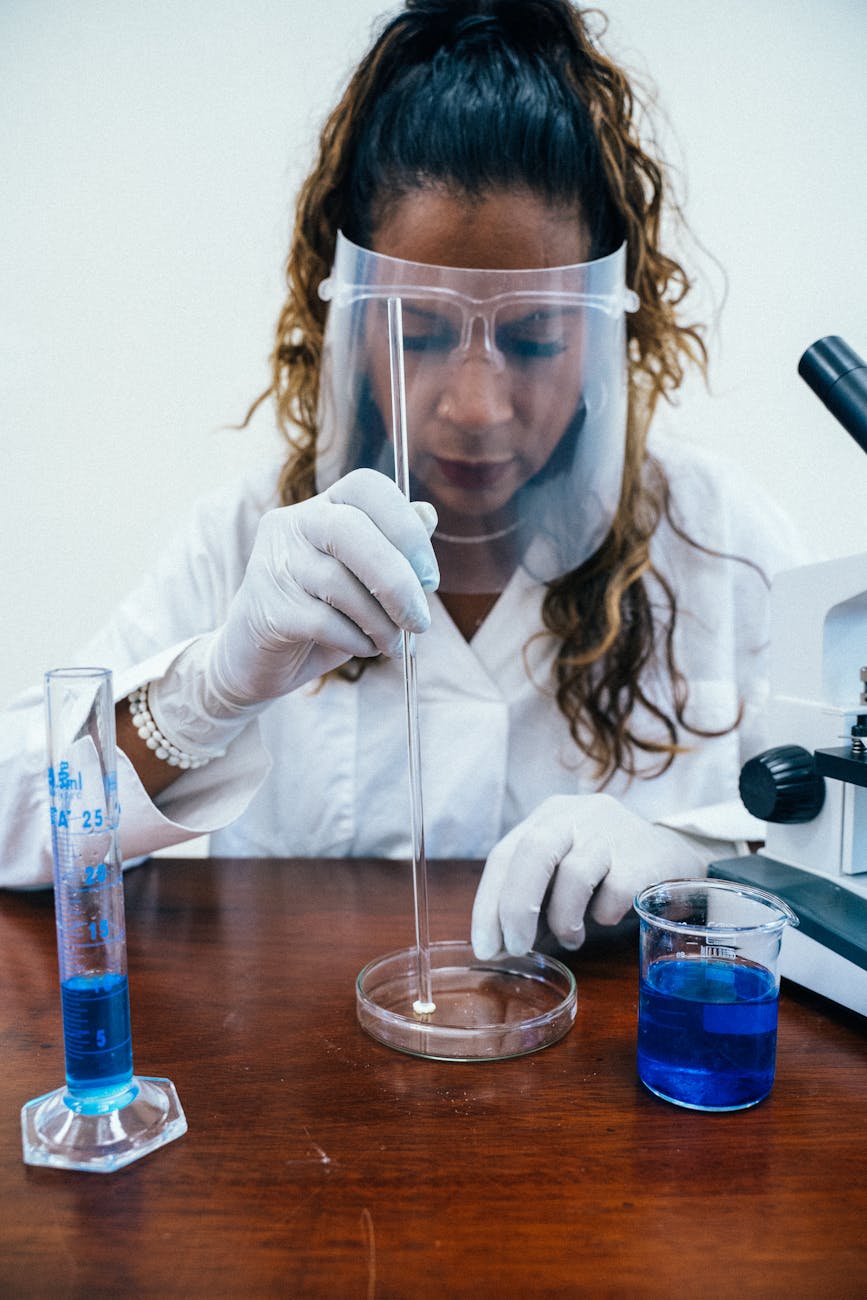 a photograph of a chemist wearing a face shield