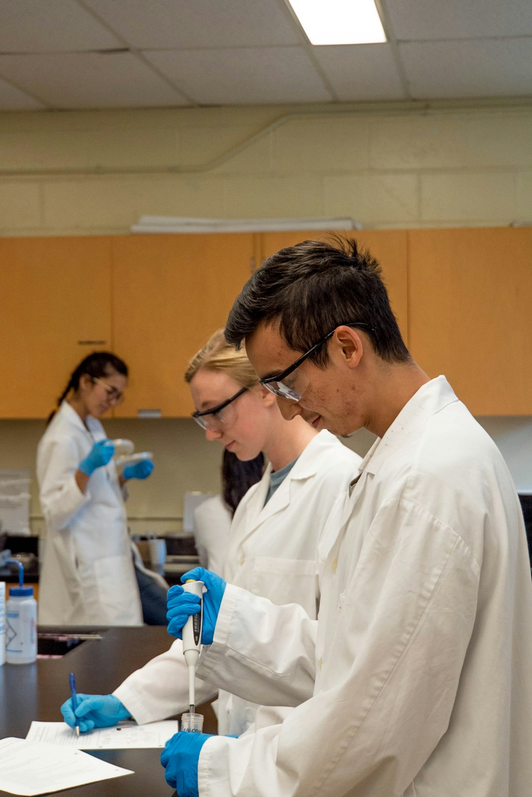 a photograph of a group of chemists weating lab coats