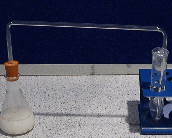 a photograph of a delivery tube connecting a conical flask to a test tube